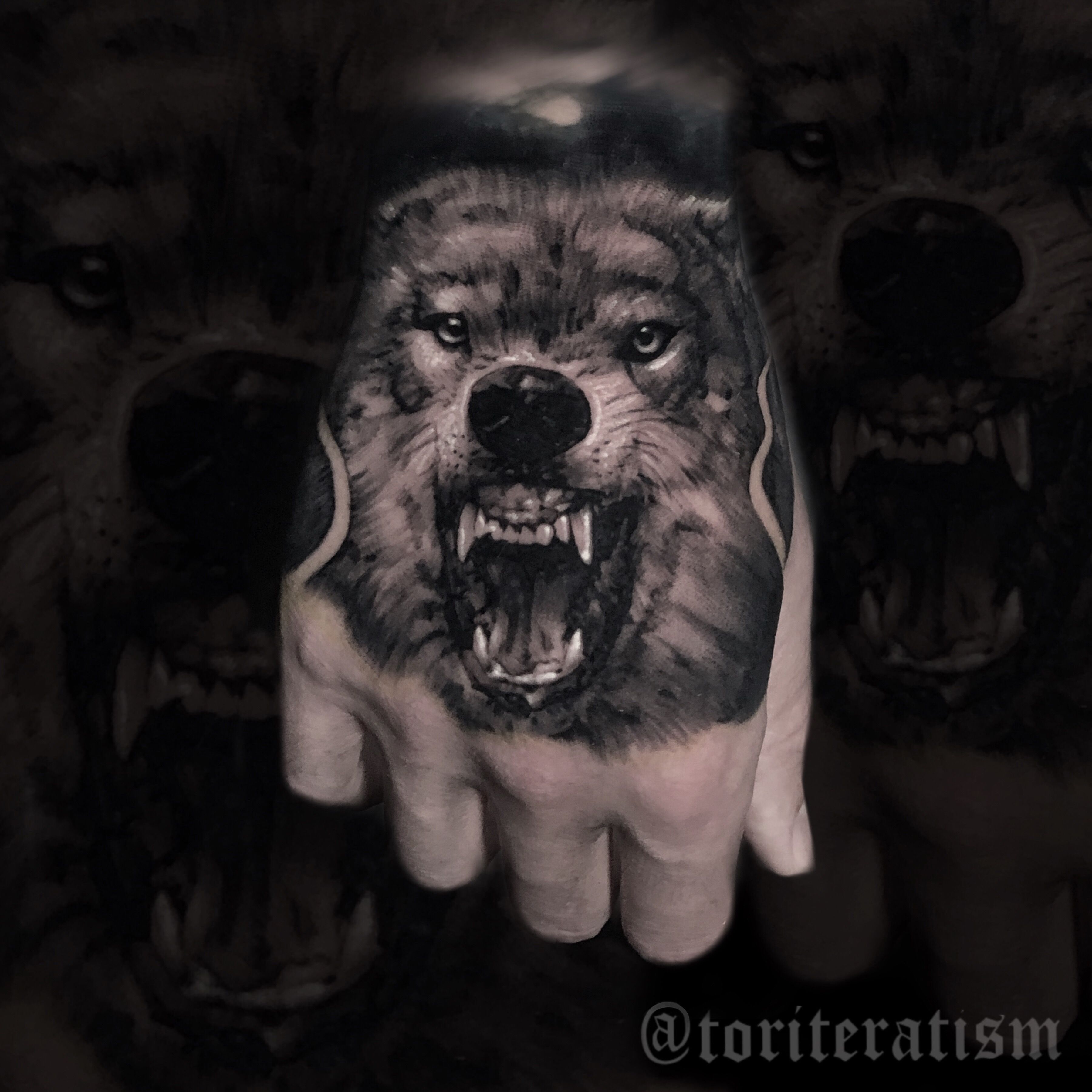 realistic wolf hand tattoo