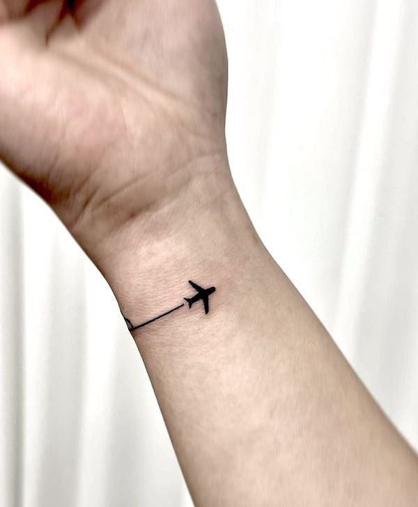 airplane tattoo on hand