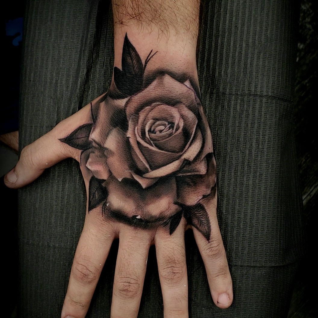 rose tattoo on hand