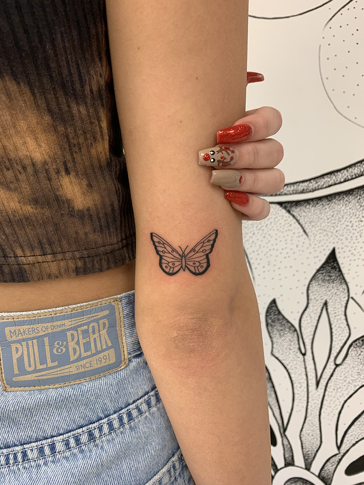 butterfly tattoo on back of elbow