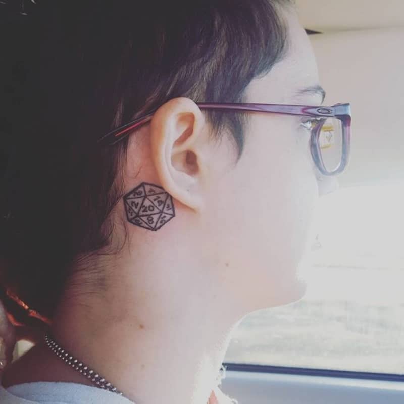 glasses tattoo behind ear meaning