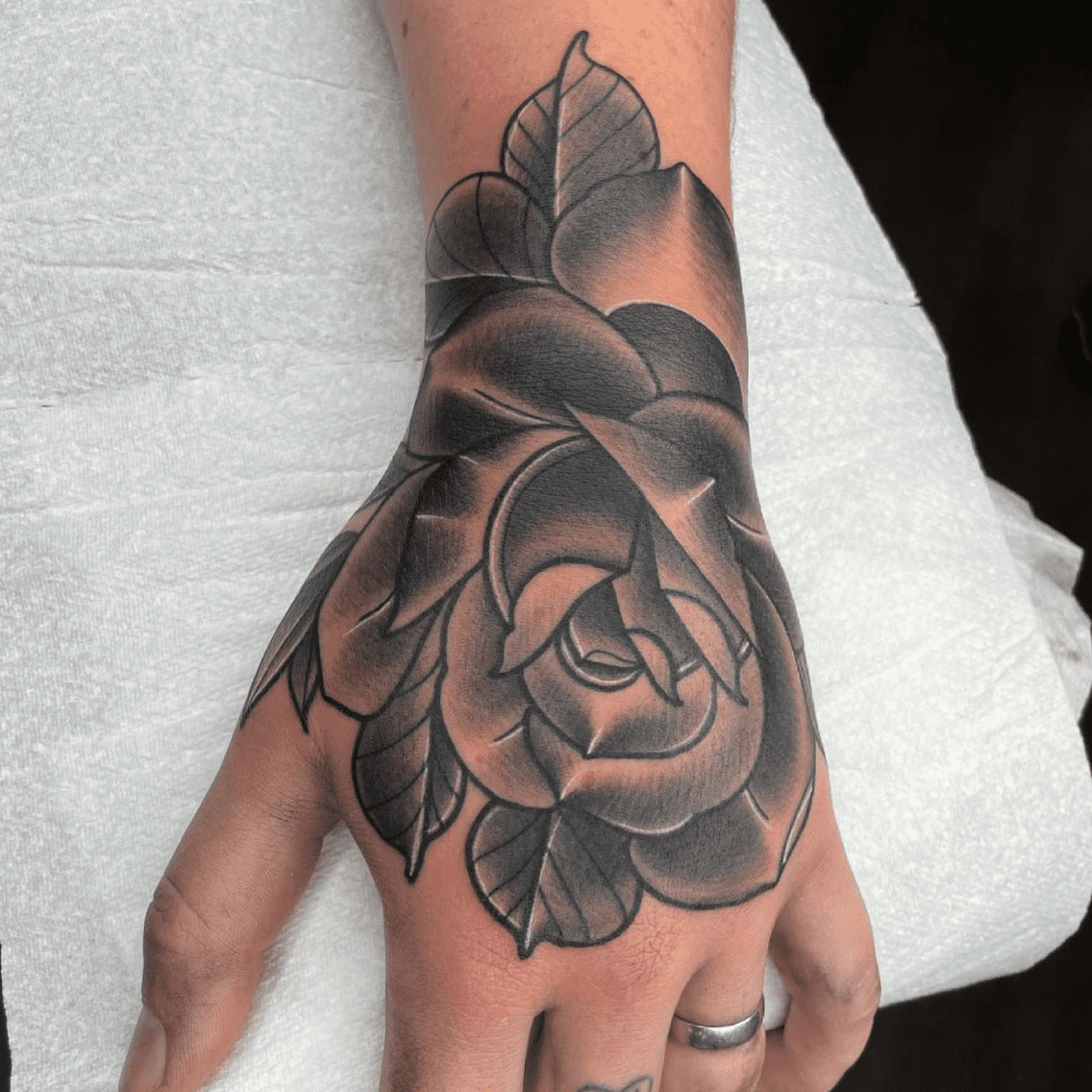 rose in hand tattoo