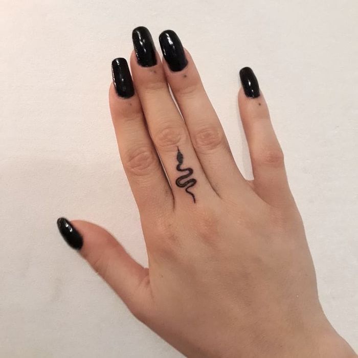 small snake tattoo on hand