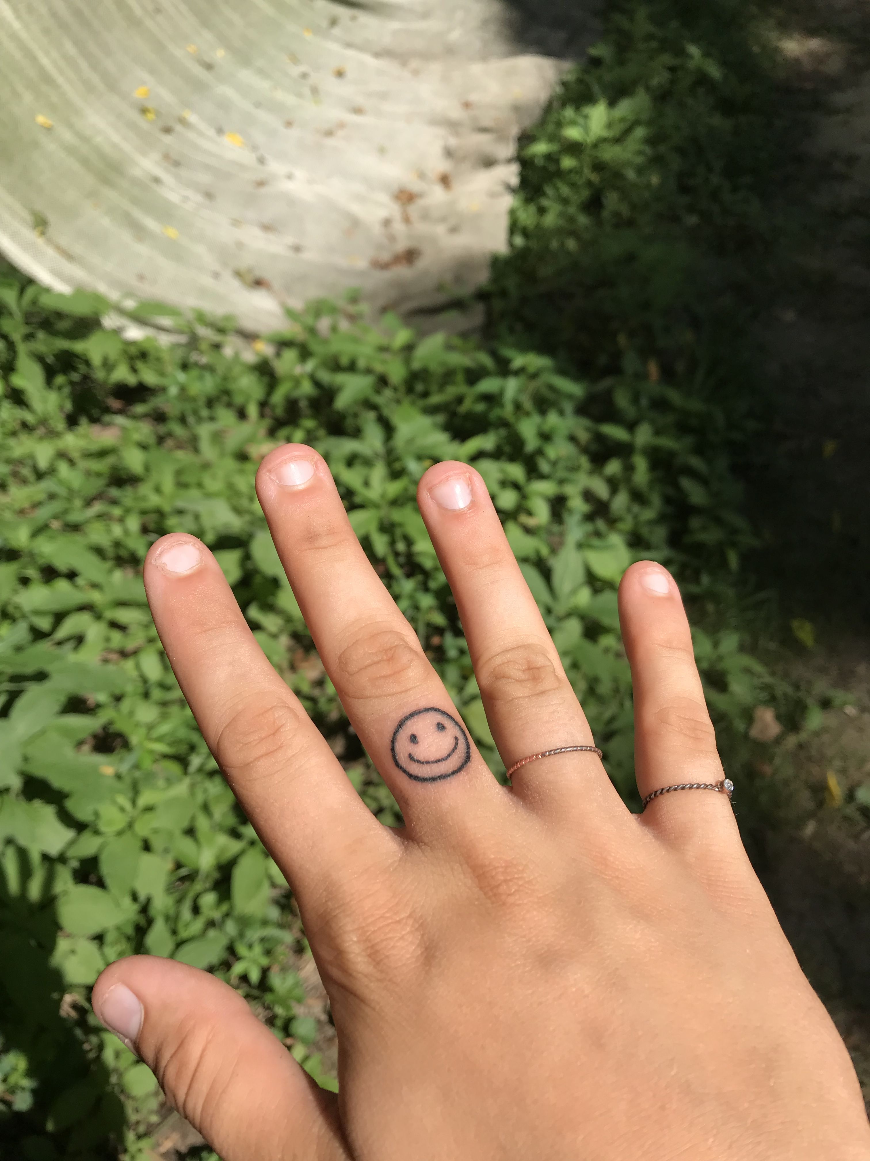 smiley tattoo finger